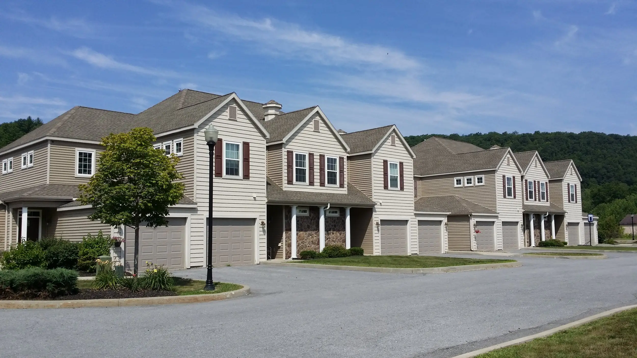 Row of two-story townhouses with attached garages